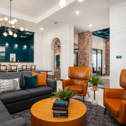 a lounge with a couch and chairs